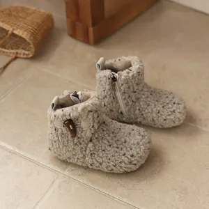 Cozy beige sherpa boots for girls with toggle button and warm lining for winter.