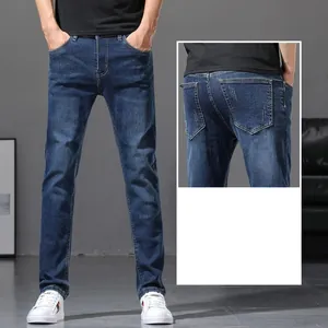 Close-up shot of men's slim fit blue denim jeans showing front and back pocket detail