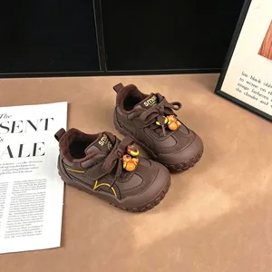 Close-up detail of brown children's sneakers with cute cartoon bear and soft plush lining