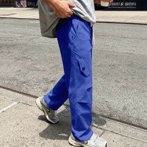 Detail side profile of men's heavyweight blue wide-leg curved street style sweatpants