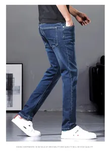 Detail side view of men's slim straight fit stretch blue denim jeans for summer