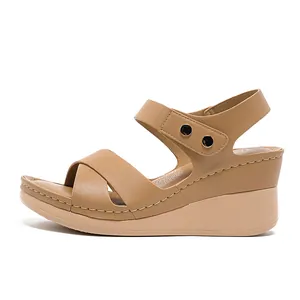Stylish women's comfortable tan wedge sandals featuring metallic buckles for 2026 summer
