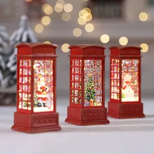 Lanternes de cabine téléphonique de Noël rouges avec figurines de Père Noël et bonhomme de neige.