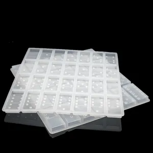 Detailed view of 28 cavities in translucent silicone domino mold for resin casting