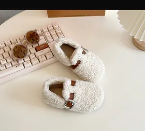 Detail view of cozy cream sheep wool baby walker shoes with stylish brown buckle straps