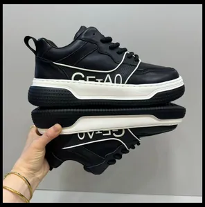 Macro view of high-end black leather sneakers with thick white platform soles.