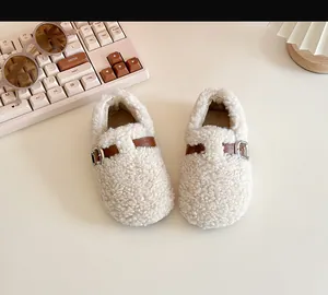 Detailed view of warm cream sherpa baby walking shoes with brown buckle strap