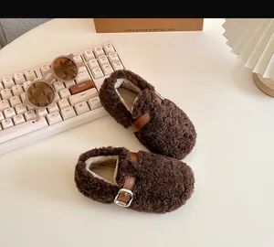 Top-down view of cozy brown faux shearling baby shoes with stylish buckle detail