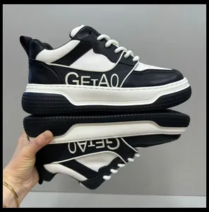Close-up detail of premium men's black and white leather sneakers with thick sole design.