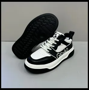 Close-up of stylish black and white leather men's sneakers with non-slip thick sole.