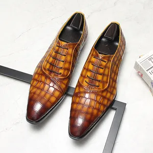 Gros plan de chaussures Derby en cuir gaufré marron avec embauchoirs sur marbre.