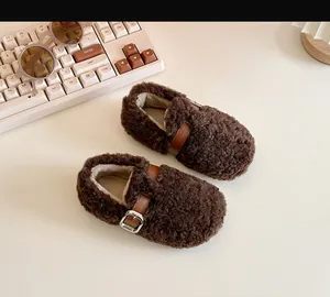 Detailed view of cozy brown sherpa baby walking shoes with leather buckle strap decoration