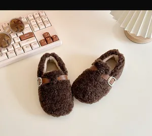 Detailed macro view of warm brown toddler fleece walking shoes with soft shearling texture