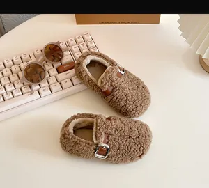 Detailed view of brown sherpa baby walking shoes with warm fleece lining and metal buckle