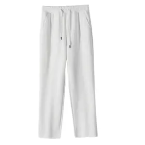 Detail showing the white cotton sweatpants with casual straight-leg cut design.