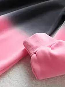 Close-up of pink and grey gradient tie-dye sweatshirt showing ribbed sleeve cuff detail