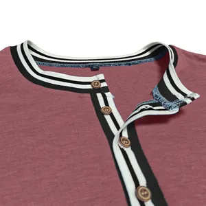 Detailed view of a maroon men's Henley shirt with striped collar and wood buttons.