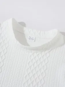 Macro detail of white textured knit sweater neckline featuring size S polyester tag