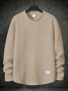 Detailed texture of beige long-sleeved sweatshirt with a minimalist patch design
