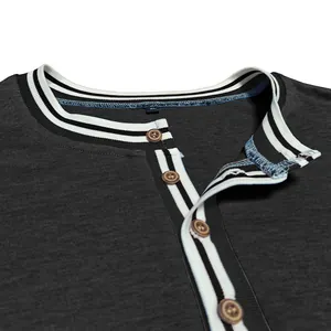 Close-up of mens dark grey Henley shirt with striped collar and wooden buttons.