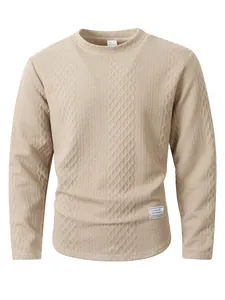 Close-up of beige textured long-sleeved sweatshirt showing fabric diamond pattern.