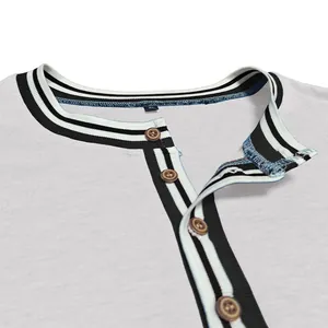 Detailed macro view of a men's color-block Henley T-shirt collar with buttons