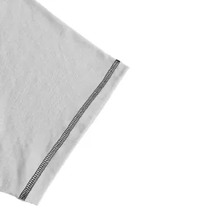 Macro view of men's t-shirt sleeve hem with detailed black contrast overlock stitching