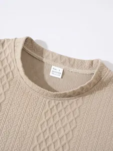 Detailed macro shot of the collar label and textured knit pattern on beige sweater