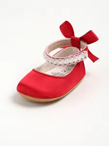 Red satin baby princess shoe featuring pearl strap and elegant bow detail for infants