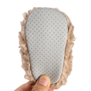 Close-up of non-slip sole on fuzzy brown newborn winter walking shoes