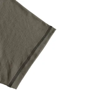 Macro shot of premium black stitching on a khaki men's cotton blend crewneck T-shirt sleeve