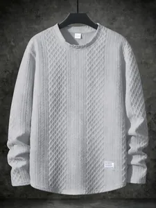 Macro view of light gray textured knit long-sleeve sweatshirt with striped pattern details