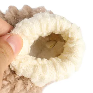 Close-up of the thick fleece lining and elastic cuff of a baby winter sock shoe.
