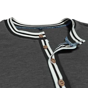 Close-up of a charcoal Henley shirt featuring striped ribbing and wooden buttons