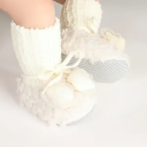 Detailed view of cream baby winter shoes featuring soft plush texture and anti-slip soles