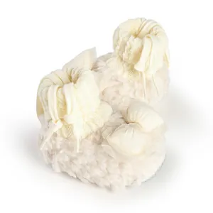 Detailed view of cream plush baby shoes featuring a delicate mesh bow and knitted cuffs.