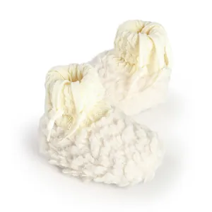 Detailed view of cozy cream-colored fuzzy baby booties with warm fleece lining for winter