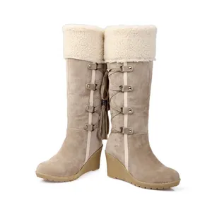 Warm high-top beige snow boots with faux shearling trim and wedge heel for women.