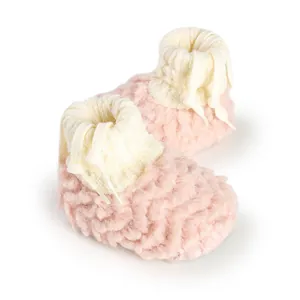 Warm and cozy pink plush baby booties featuring soft white knitted cuffs and drawstrings