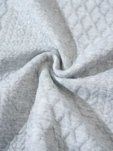 Macro view of light gray quilted fabric texture for casual sweatshirt.
