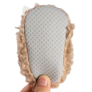 Detailed close-up of the non-slip dotted sole on plush baby winter booties with soft fur.