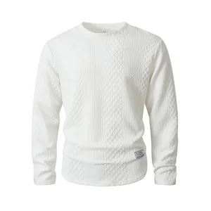 Detailed macro view of a white long sleeve crewneck sweater with cable knit texture