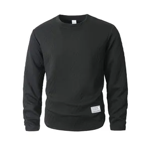 Detailed view of black crewneck sweatshirt featuring a unique textured diamond knit pattern