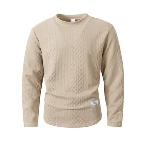 Detail showing the textured diamond knit pattern on this beige long-sleeved sweatshirt