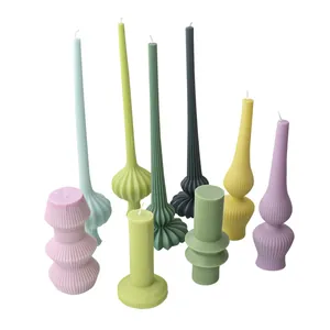 Detailed view of colorful ribbed pillar candles in various Nordic geometric shapes
