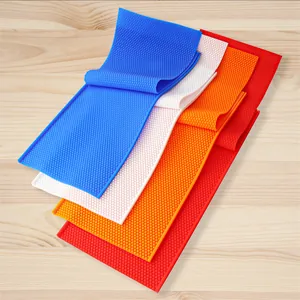 Detailed view of honeycomb-textured silicone molds in blue, white, orange, and red