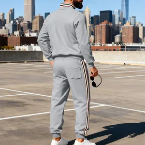 Back view of men's grey heavy tracksuit featuring contrast stripes on collar and pants.