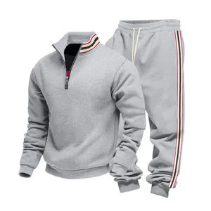 Close-up of men's grey heavyweight tracksuit with striped ribbon detail on collar and pants.