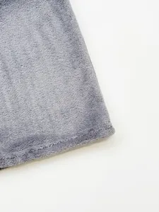 Close-up detail of soft gray flannel fabric and stitching on men's warm trousers