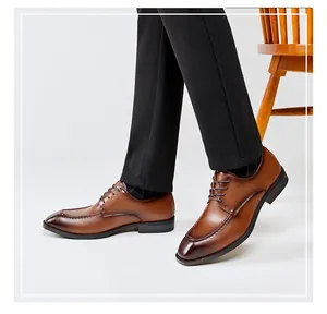 Close-up view of men's brown square-toe leather Derby shoes worn with black trousers.